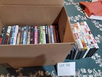 Box of assorted DVD movies and shows, showing variety and quantity.