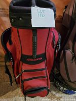 Front view of the red Mizuno golf bag showing the multiple zippered compartments and logo.
