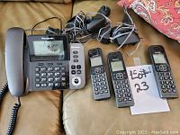 Overview of the Panasonic corded phone base and three cordless handsets with their wiring and power adapters visible.