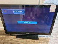 Front view of the Samsung TV showing screen with 'No Time Information' and 'Check signal cable' messages.