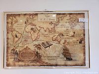 Vintage styled world map depicting the Voyage of the HMS Bounty with artistic elements and sailing ship, framed and hung on wall.