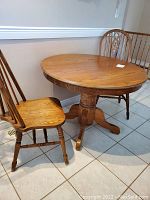 Table and two chairs on tiled floor, overall view of lot