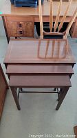 Set of three Gibbard wood nesting tables stacked together showing size progression and finish.
