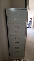 Full view of the four drawer metal file cabinet showing all drawers and overall height.