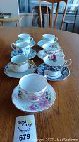 Group view of all tea cup and saucer sets on table
