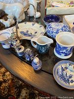 View of all stones items on table showing salt and pepper shakers, heart-shaped container, miniature creamer, blue and white bowls and trays.