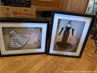 Two framed shadow box displays side by side on wood floor