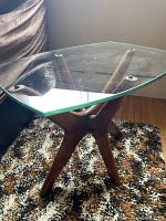 Angled view of hexagonal glass top and solid wood base