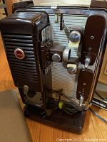 Close-up photo of vintage Kodak Showtime 8mm movie projector showing control knobs, power cord, and metal body