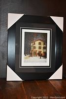 Front view of framed and matted print showing the artwork and frame corners with protective coverings.