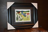 Framed artwork showing overall black frame with protective cardboard corners, setting the scene of the item.