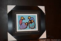 Framed artwork showing the owl print with protective corners on frame edges.