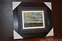 Full view of professionally framed and matted art print with corner protectors on frame.