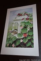 Full view of the fine art print showing bird on white lantern with surrounding leaves and flowers.