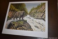 Full view of the fine art print showing bear, river, rocks, and trees