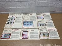 Six large informational sheets laid out on table featuring 1979 commemorative stamp blocks of endangered flora and botanical themes.