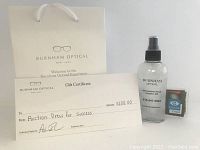 Branded Burnham Optical gift bag with gift certificate, eyeglass cleaner spray bottle, and cleaning cloth