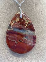 Full view of the Picasso Jasper teardrop-shaped pendant on a 925 sterling silver chain showing the overall colors and pattern of the stone and silver bale.