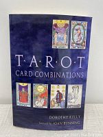 Front cover of the paperback book titled 'Tarot Card Combinations' by Dorothy Kelly, featuring images of Tarot cards on a blue background.