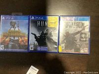 Three PlayStation 4 game cases shown side-by-side on a dark surface.