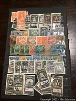 Photo showing assorted Canada back of the book revenue stamps, various colors and denominations
