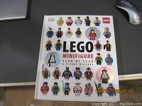Full front cover of the Hardcover Lego Minifigure Year by Year Visual History book with various minifigure images.