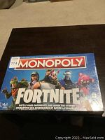 Top view of Monopoly Fortnite board game box featuring Fortnite characters and branding, showing it is sealed new in box