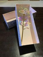 Box containing a 9-inch crystal rose with 24K gold-plated stem and leaves.