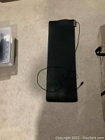 Full view of the extended black Razer Goliathus gaming mousepad on floor showing USB cable for lighting.