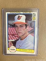 Front side of the 1982 Donruss Cal Ripken Jr. rookie baseball card showing him in an Orioles cap and jersey holding a bat, labeled 'ROOKIE CARD' and with the Donruss 82 logo.