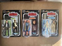 Three Star Wars Empire Strikes Back 40th Anniversary figures in original sealed packaging: Han Solo, Lando Calrissian, Princess Leia in Hoth gear.