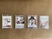 Photo showing all four rookie cards side by side, featuring autographs and jersey patches.