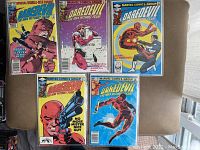 Five Daredevil comics (#181-185) laid out on sofa