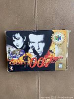 Front of original Goldeneye 007 Nintendo 64 game box showing James Bond and Game of the Year sticker.