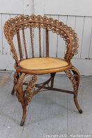 Side angle showing intricate wicker spiral design and cane seat