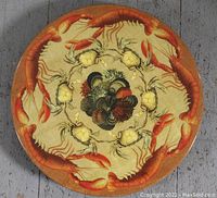 Top view of the circular wooden lazy Susan showing hand painted lobsters and crabs arranged around a central decoration.