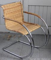 Full view of chair showing chrome cantilever base and cane surfaces