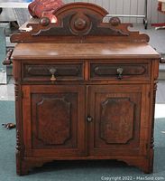 Full front view of the carved wooden buffet showing overall design and condition