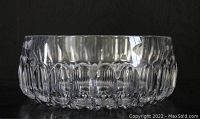 Side view of the heavy crystal thumbprint bowl showing the textured pattern and clear glass material.