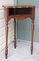 Full view of the vintage Middlesex Furniture telephone stand with turned legs and open shelf.