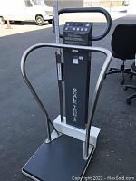 Full view of the heavy duty Scaletronix commercial scale showing the platform, stainless steel safety handles, and control unit on a pole.