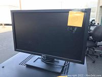 Photo of one Dell computer monitor showing flat screen with black bezel and stand.