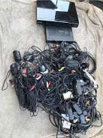 Multiple security cameras with attached cables including RCA and power connectors, tangled and grouped in one pile.