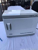 Front view of closed ForPro Premium Hot Towel Warmer cabinet showing brand and model name.