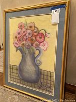 Side angled view of framed original wall art with floral vase and signature L2004