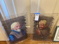 Two artworks displayed side by side against a wall. Each artwork shows an elderly person and is covered with clear plexiglass attached with screws.