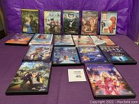 Photo showing all 17 DVDs arranged in rows, covers visible including Cinderella, Alice Through the Looking Glass, Maleficent, Big Hero 6, Frozen II among others.