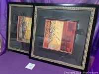Two framed Don Li-Leger prints displayed side by side, showing the decorative black frames with silver detailing and black mats with red border accents.