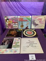 Front view of the 14 vinyl records with their album covers laid out, showing titles and artwork including 'If I Loved You,' 'Leroy Anderson,' and others.