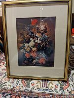 Full frontal photo of the framed flower print showing the multi-colored floral arrangement with the gold wood frame and off-white matting.